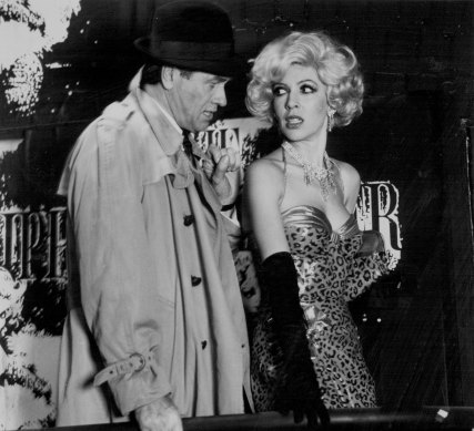 “The Stripper”  Terence Donovan as Lt. Al Wheeler and Robyn Moase as Deadpan Dolores in “The Stripper”
