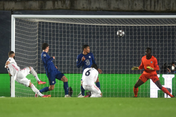 Real’s Karim Benzema scores his side’s equaliser against Chelsea in Madrid.