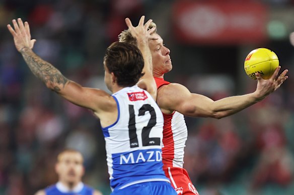 Isaac Heeney of the Swans takes a mark.