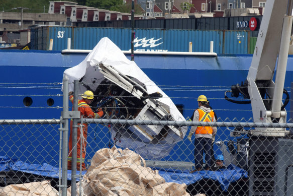 Debris from the Titan submersible, recovered from the ocean floor near the wreck of the Titanic, is unloaded from the ship Horizon Arctic at the Canadian Coast Guard pier in St. John’s, Newfoundland.