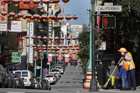 A worker cleans a street in San Francisco’s Chinatown. Police stepped up patrol and volunteers increased their street presence after several violent attacks on older Asians in the city’s Bay Area. 