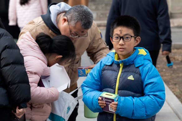 The Beijing Catholic community mark the beginning of the Lent period with ash crosses for a service at Xishiku Cathedral. 
