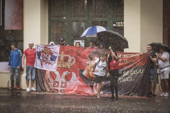 Novak Djokovic supporter Sofia Heregovac (red t-shirt) leads a traditional dance in support of the detained tennis player outside the  Park Hotel where he  is being held by Border Security, along with refugees held in detention.