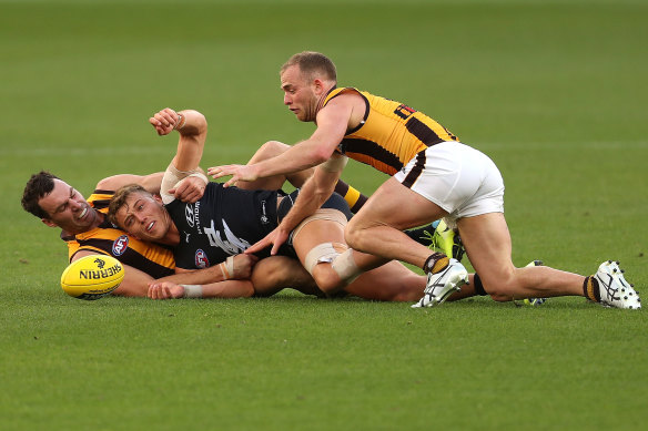 Jon Ceglar and Tom Mitchell teamed up to tackle Patrick Cripps at Optus Stadium last Friday.
