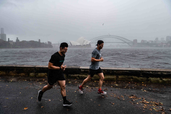 People exercising in the rain on Wednesday morning.