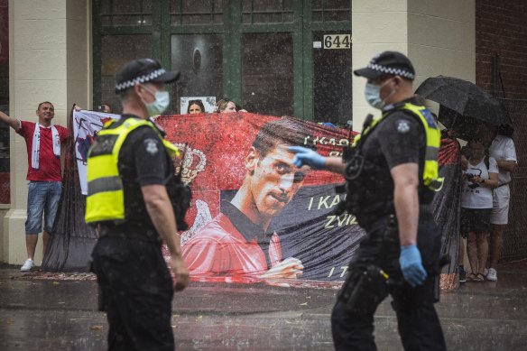 Novak Djokovic supporters protest   outside the Park Hotel where he is being held, along with refugees in detention. 