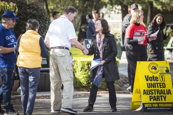 Chisholm MP Gladys Liu hands out how-to-vote cards at the Mount Waverly pre-polling centre.