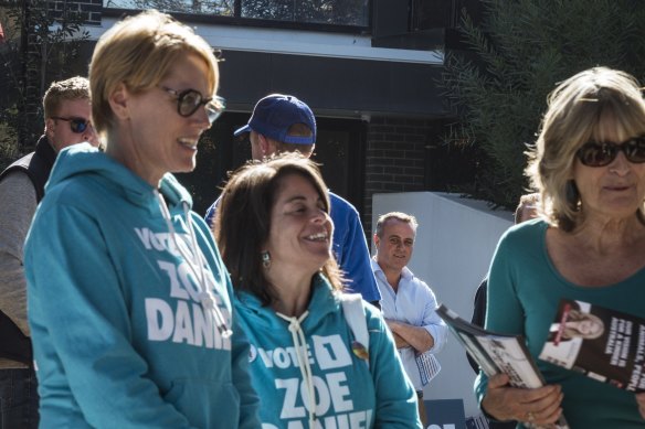 Tim Wilson glances at independent candidate Zoe Daniel as she campaigns at Beaumaris Secondary College on Saturday.