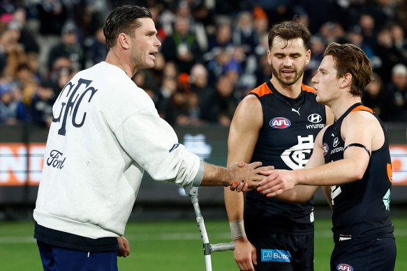 Tom Hawkins shakes hands with Carlton players.
