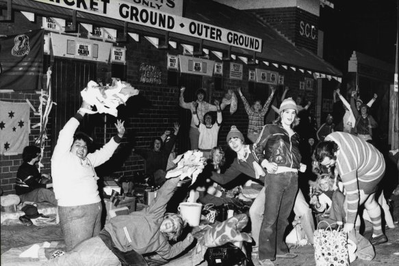 Fans wait overnight for the gates to open at 8am for the Rugby League grand final.