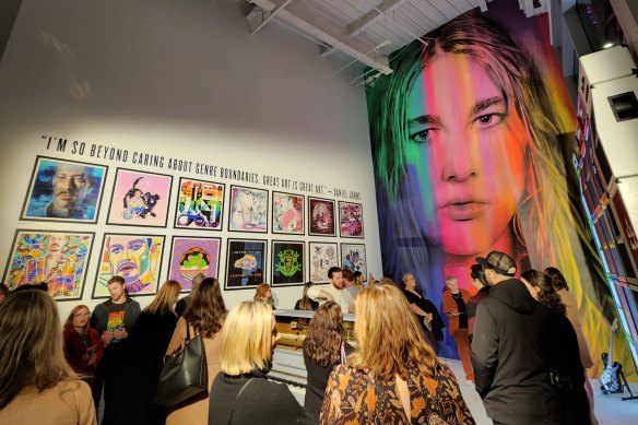 Guests in front of a giant Daniel Johns mural at the exhibit Past, Present and FutureNever  in Melbourne.