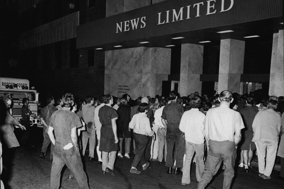 Employees of New Ltd in the street after they were evacuated from the building before a bomb exploded in a toilet block on the 4th floor. April 14, 1973. 