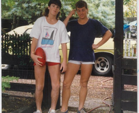 James Hughes with his footy and brother Karl in 1986.