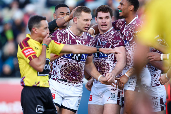 Manly congratulate Tom Trbojevic after one of his three tries.