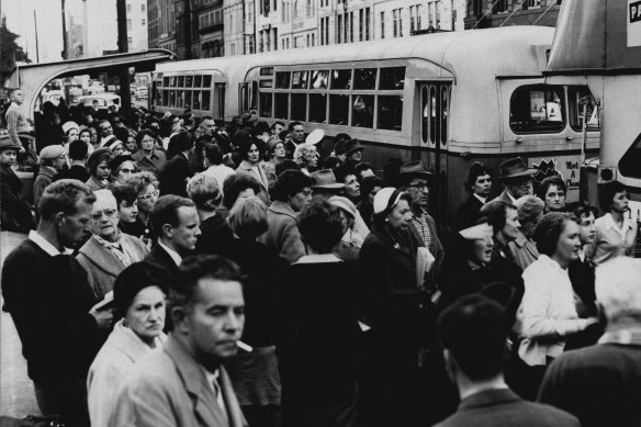 “A marked up-swing in psychological, emotional and spiritual poverty.” Commuters on Elizabeth Street, Sydney on July 2, 1962.