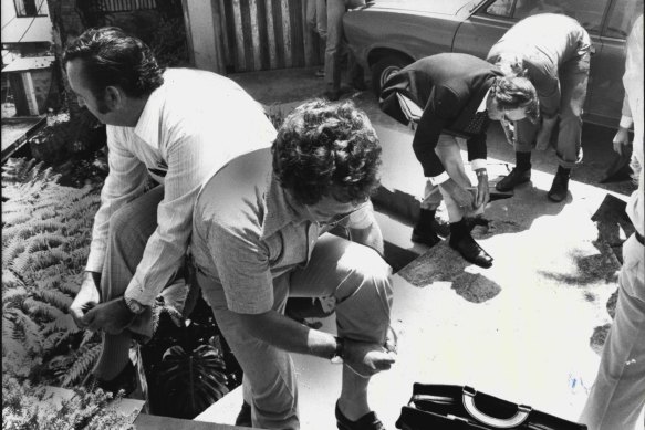 Union officials and anti-uranium campaigners visited the site in the 1970s. They are seen rolling up their trouser cuffs before entering the site.