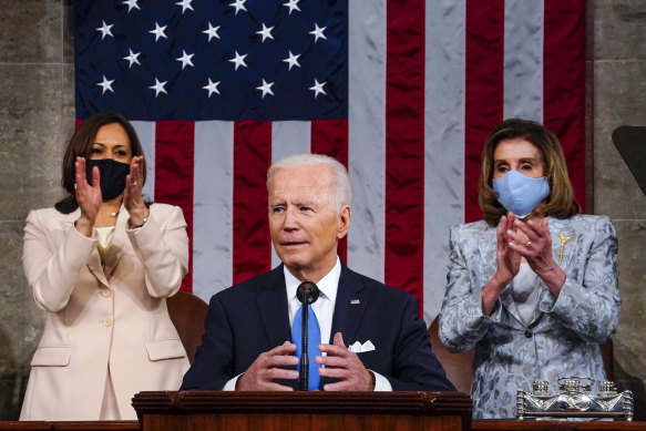 Vice-President Kamala Harris and House Speaker Nancy Pelosi stand and applaud as President Joe Biden addresses a joint session of Congress at the US Capitol in Washington. 