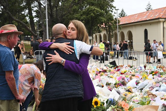 Liberal leader Kellie Sloane comforts mourners at Bondi Beach. 
