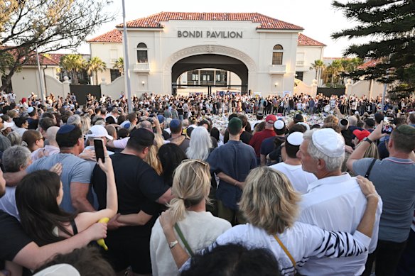 Mourners gather at Bondi Beach following the tragedy. 