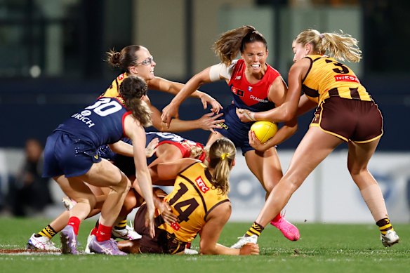 Kate Hore of the Demons is tackled by Lucy Wales.
