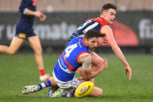 The Demons’ Bayley Fritsch and Bulldog Marcus Bontempelli battle for possession.