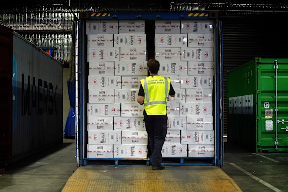 A Border Force officer inspects a container of illegal cigarettes.