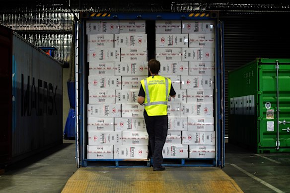 A Border Force officer inspects a container of illegal cigarettes.