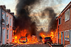 Vehicles set on fire by protesters burn on Lendrick Street in east Belfast, Northern Ireland.