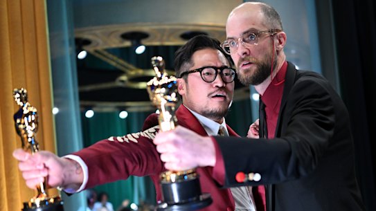 Daniel Kwan and Daniel Scheinert backstage at the Oscars with their awards for best original screenplay. 