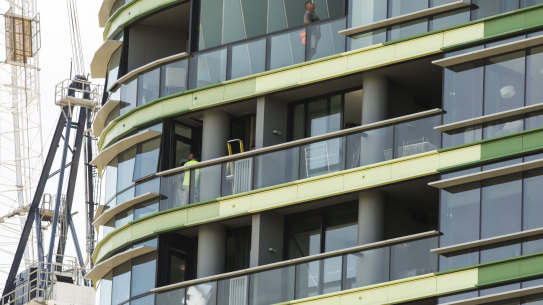 Tradesmen working on the Opal Tower at Sydney Olympic Park
