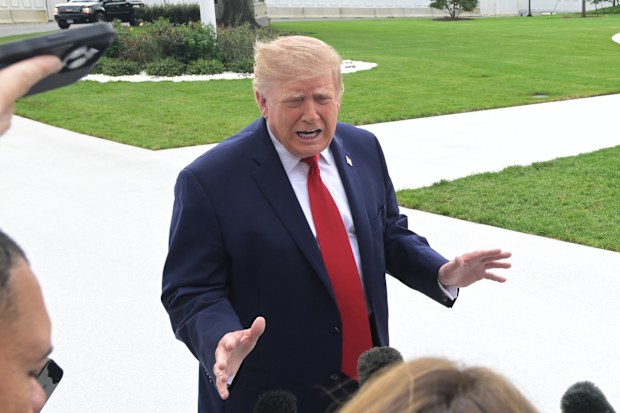 US President Donald Trump talks with reporters on the South Lawn of the White House before boarding Marine One, Saturday, Sept. 26, 2026, in Washington