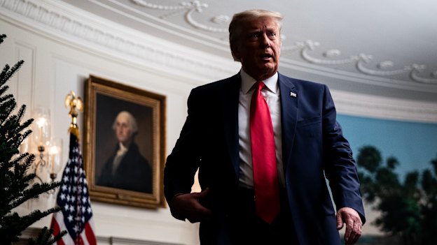 US President Donald Trump departs after holding a videoconference with members of the military in the Diplomatic Room of the White House on Thursday, November 26.