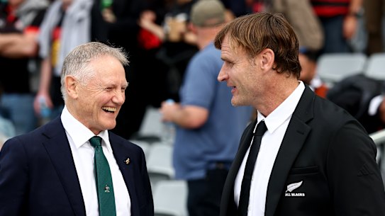 Coach Joe Schmidt of Australia talks with coach Scott Robertson of New Zealand