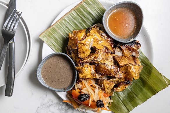 Lechon, pull-apart roast pork with shatter-crisp crackling that's flavoured with lemongrass and ginger, and served with liver sauce (left) and vinegar (right).
