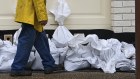 A resident of Graceville, a Brisbane suburb prone to flooding, sand bags his house on Friday.