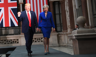 US President Donald Trump and British Prime Minister Theresa May arrive for a press conference in London on Tuesday.