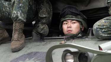 A Taiwanese soldier watches from a tank during military exercises in Taichung on Thursday.