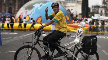A man rides protests climate change in Mexico City on Friday, as thousands of people took the streets around the globe  in the run-up to a UN summit to demand leaders tackle the problem.