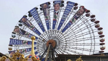 A Beirut Ferris wheel is used in the election campaign of Lebanese Prime Minister Saad Hariri , left.