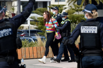 Police arrest a protester in St Kilda on Saturday.