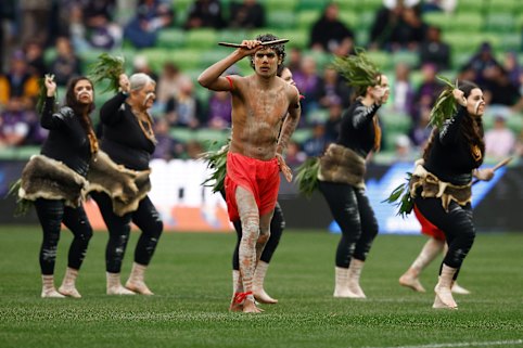 Indigenous dancers perform during the Welcome to Country before a Melbourne Storm-Cronulla Sharks match.