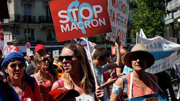 Protesters rally in Paris on Saturday, demanding President Macron back down from proposed reforms.