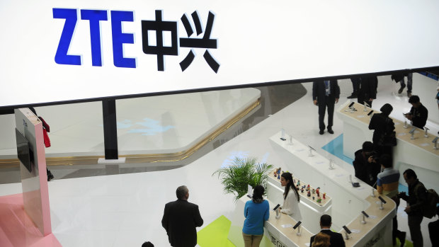 People gather at the ZTE booth at the Mobile World Congress in Barcelona, Spain. 