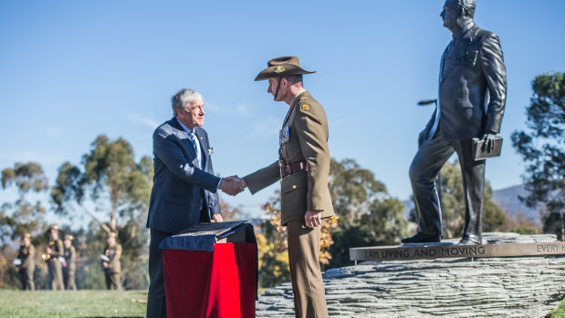 Australian War Memorial Council chair Kerry Stokes and Chief of Army Lieutenant General Rick Burr unveil the plaque beside a commemorative sculpture of General Sir John Monash.