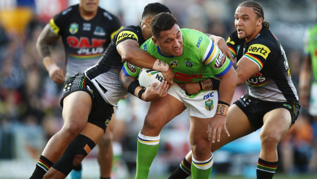 Josh Papalii is wrapped up by the Panthers' defence.
