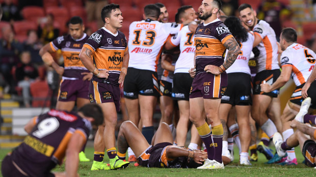 Agony and ecstasy: Brisbane players come to terms with another narrow defeat.