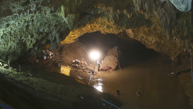 Thai rescuers work at the entrance to the cave.