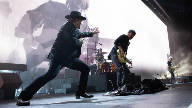 U2 frontman Bono, lifting the spirits at Perth's Optus Stadium with guitarist The Edge, bassist Adam Clayton and drummer Larry Mullen.