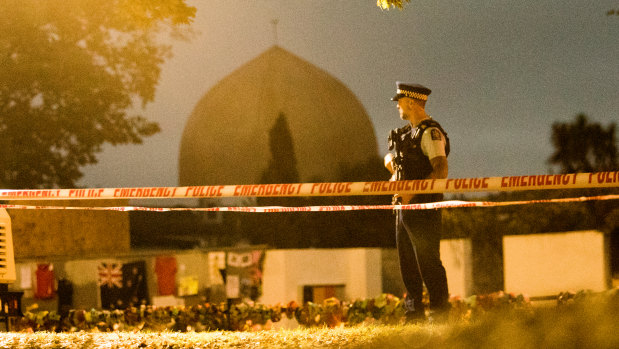 A policeman stands gaurd at the Al Noor Mosque early on Friday morning.