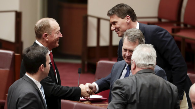 Fraser Anning is congratulated by Cory Bernardi after delivering his first speech in the Senate.